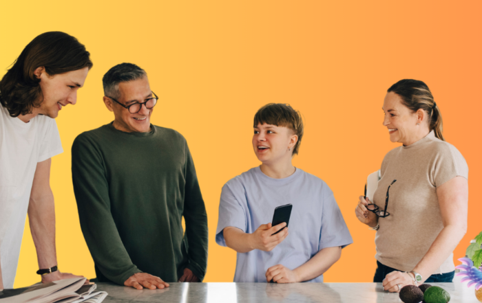 Family gathered around a kitchen island with their trans family member laughing as one at the anti-trans material they're seeing on social media because they feel so confident and supported on their collective gender journey